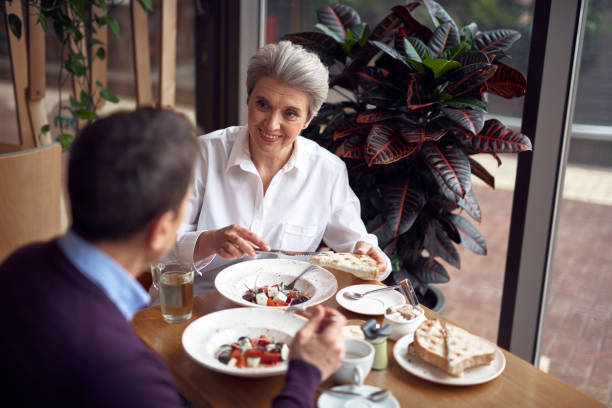 istock Aged smiling elegant woman with roasted bread 1149343877