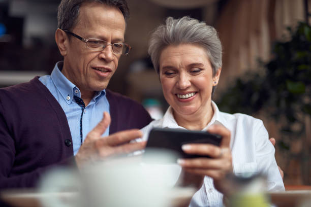 istock Aged couple look with interest in mobile phone 1149343928
