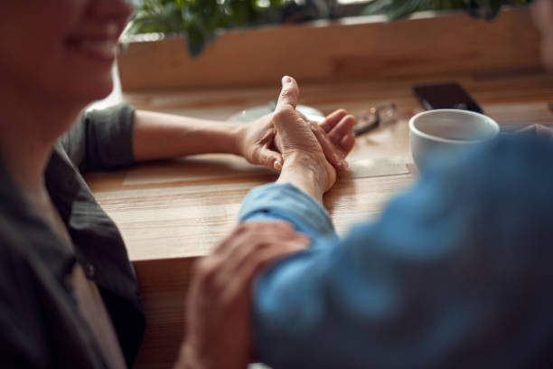 istock Close up happy couple holding hands in cafe 1149345405