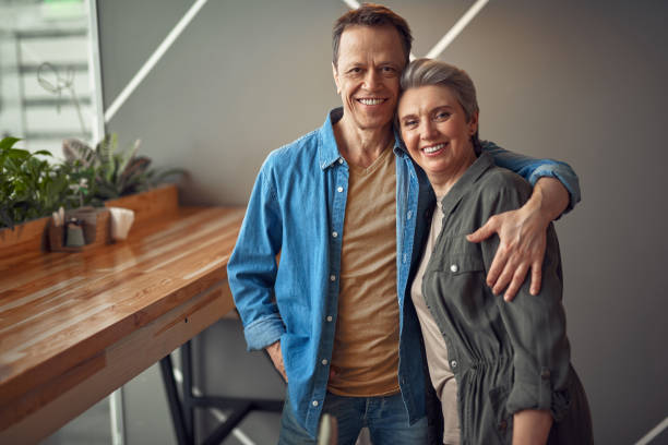 istock Cheerful aged couple embracing tenderly in cafe 1149345424