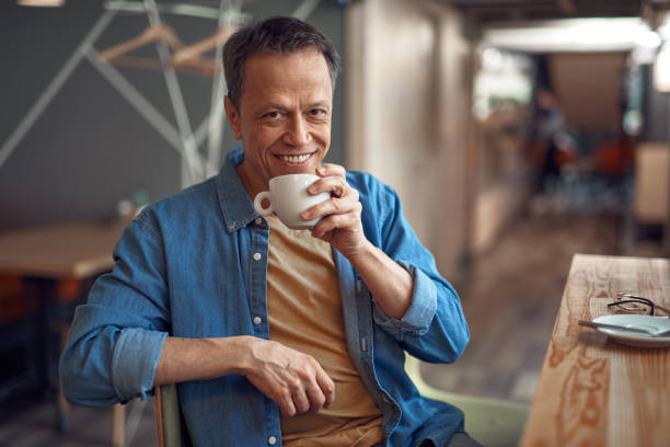 istock Happy mature man sitting in cafe with coffee 1149345437