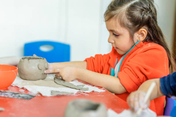 istock Cute Little Girls making Cremic 1149346243