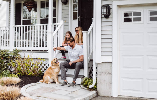 happiness family with the dog in front of their house happiness family with the dog in front of their house in front of stock pictures, royalty-free photos & images