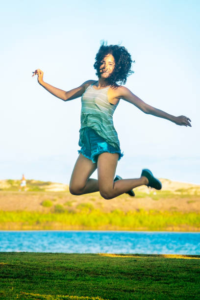 istock Young girl jumping in the park 1149353933