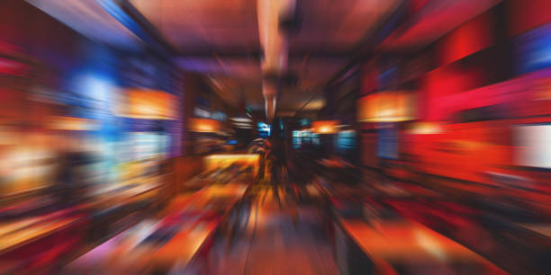 Blurred cafe restaurant background night time, modern Coffee shop blur background with colorful bokeh