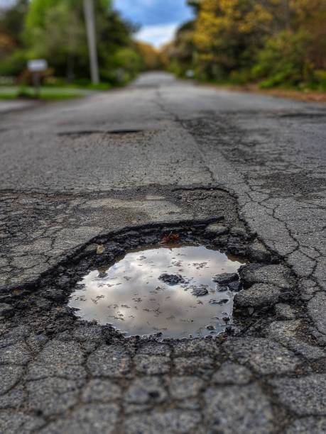 istock Pot hole filled with water 1149357417