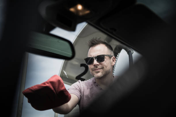 istock Man wiping windshield after a car wash 1149361360