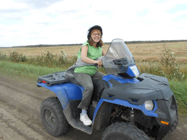 istock woman driving a quad 1149365692