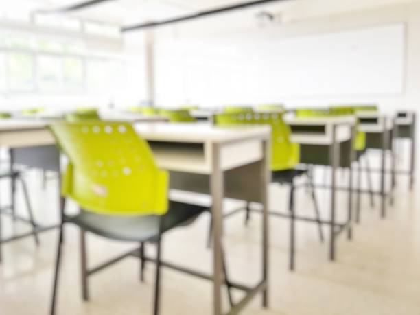 istock School classroom in blur background without young student; Blurry view of elementary class room no kid or teacher with chairs and tables in campus. 1149368104