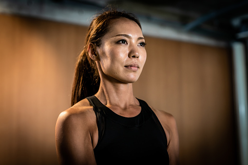 Portrait of a Japanese female standing in a gym