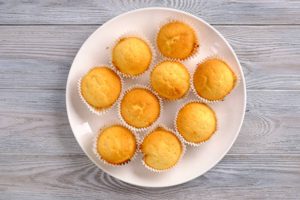 istock Lemon muffins with coffee on a white wooden table 1149376010