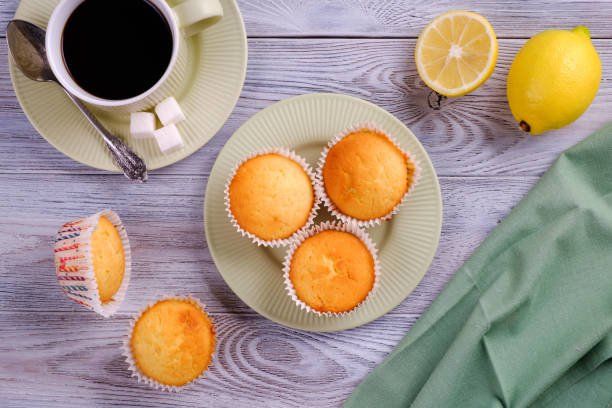 istock Lemon muffins with coffee on a white wooden table 1149376026