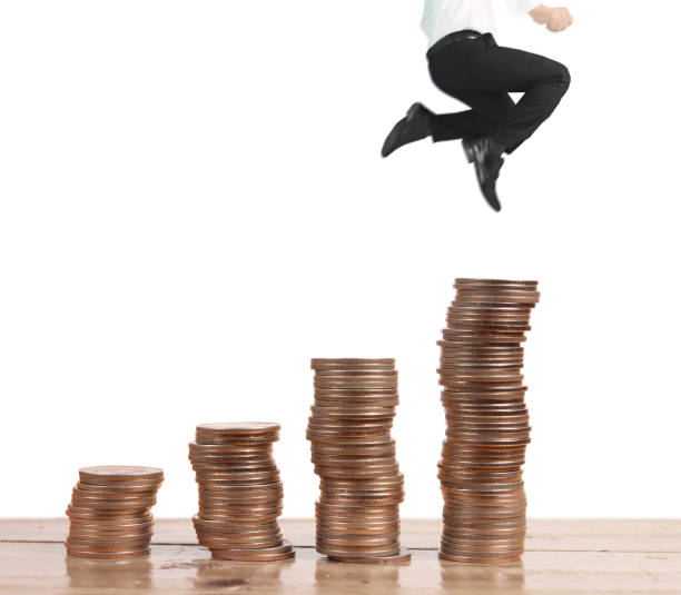 istock Businessman walk on stack of coins which grows success 1149386594