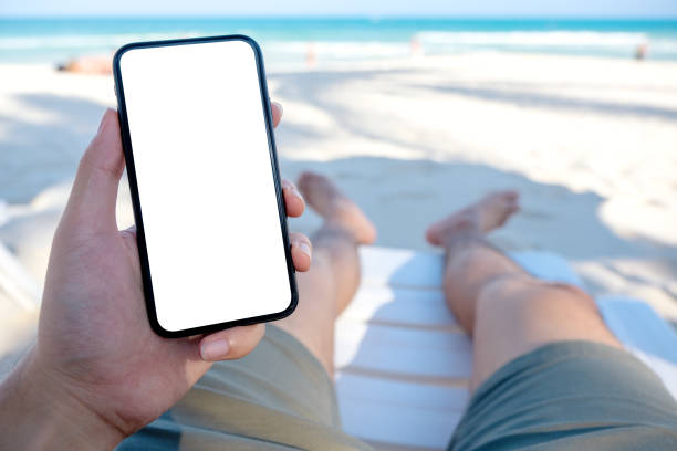 istock a man's hand holding black mobile phone with blank desktop screen 1149388476