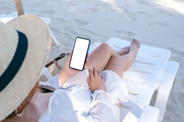 istock a woman holding white mobile phone with blank desktop screen 1149388477