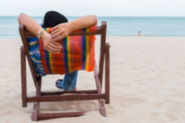 istock man relaxing on beach chair on the sand with sky 1149392207