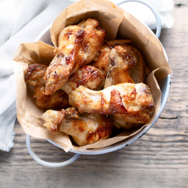 istock Fried Chicken Wings on wooden table. 1149395484