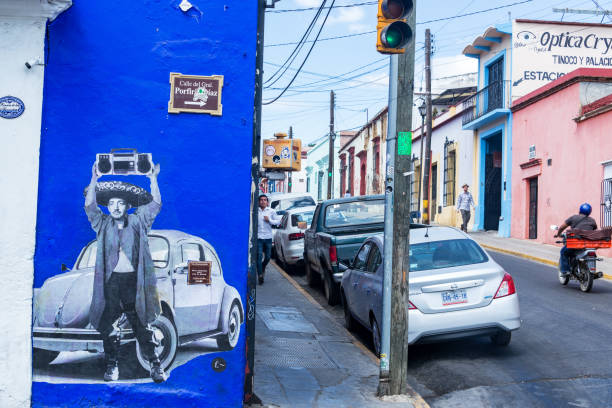 rio de janeiro, brazil- may 20, 2010: men walk away from each other with graffiti of an evil visage accentuating the broad socioeconomic gaps that exist in rio.  brazil has one of the greatest disproportions of wealth distribution in the world. crime, and social instability often result.