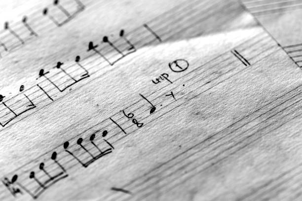 istock Page of an old musical notebook with hand written notes close up. Black and white 1149397213