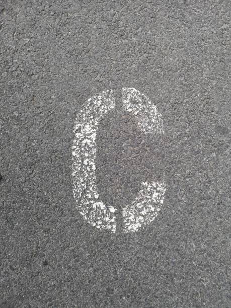 istock Letter C stenciled in white on asphalt 1149399526