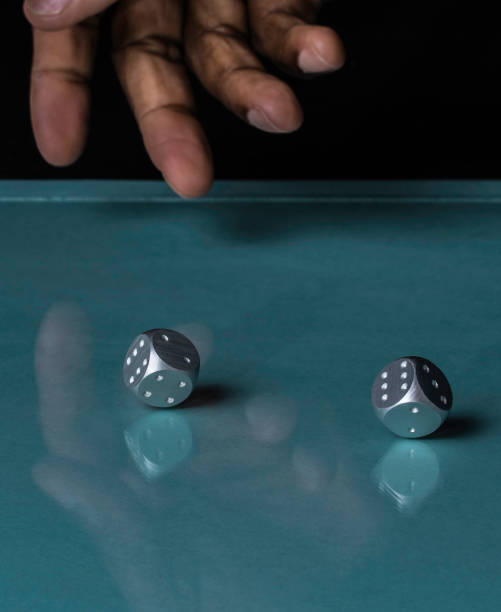 istock Rolling two silver steel Dice In a Casino 1149399538