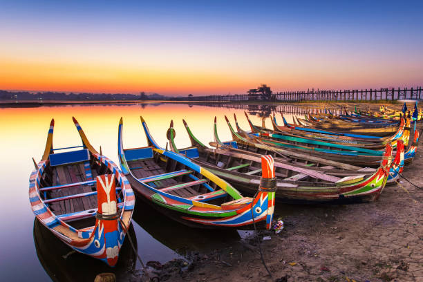 sunrise in the morning at ubein bridge with a boat sunrise in the morning at ubein bridge with a boat Amarapura stock pictures, royalty-free photos & images