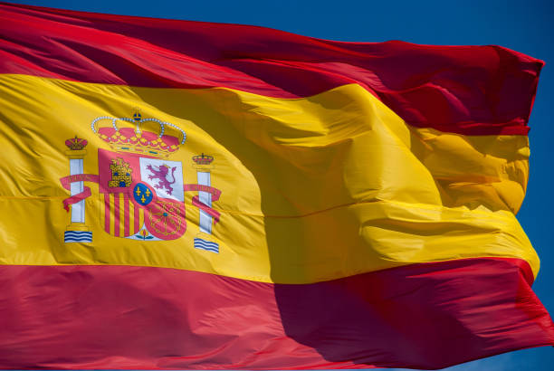 istock flag of spain waving in wind on a pole 1149402704