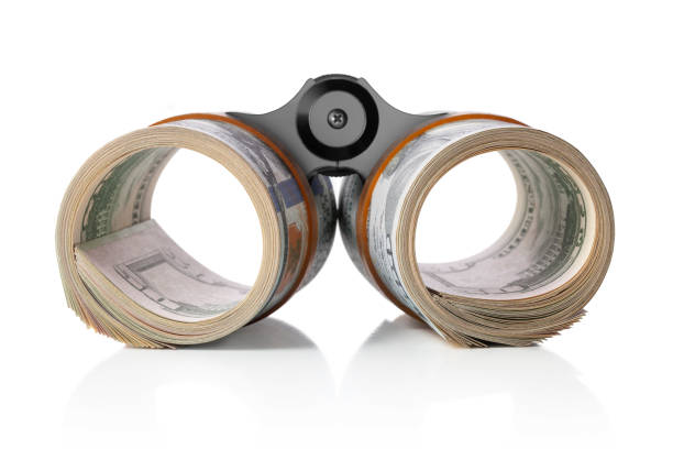 Dollars binoculars. Rolls of dollar banknotes like binoculars on white background.