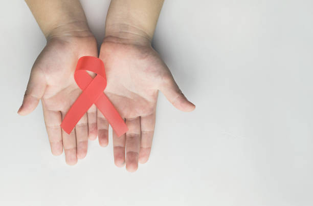 istock Kid hands holding red AIDS awareness ribbon. Aids Awareness 1149406217
