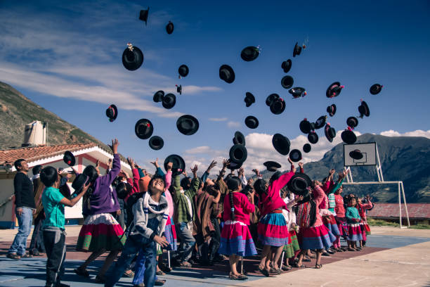 Peruvian children throwing hats to the sky stock photo