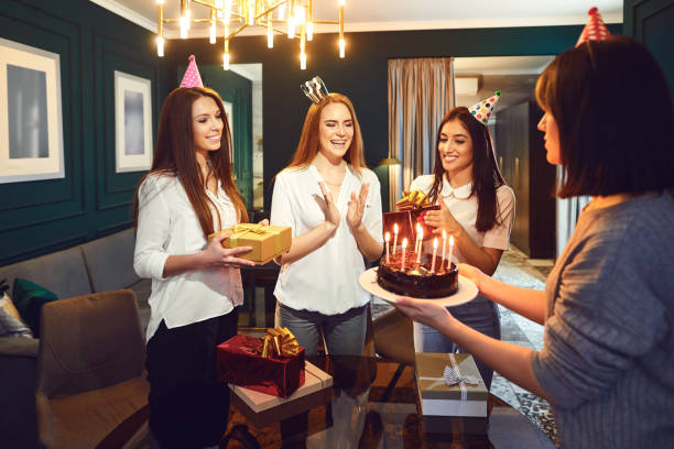 istock Smiling women with presents and cake having party 1149412929