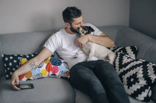 istock Young men at home with his dog 1149412997