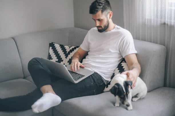 istock Young men at home with his dog 1149413095