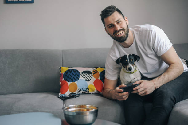 istock Young men at home with his dog 1149413106