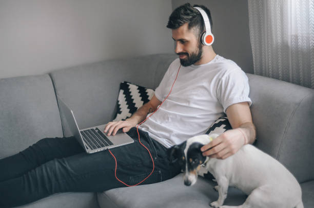 istock Young men at home with his dog 1149413107