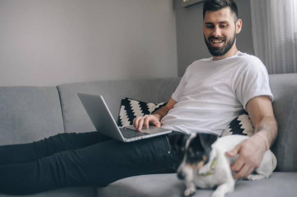 istock Young men at home with his dog 1149413148