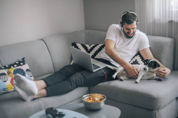 istock Young men at home with his dog 1149413209