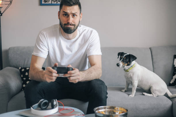istock Young men at home with his dog 1149413260