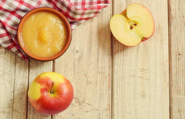 istock Apple puree in bowl on wooden table top view 1149413597