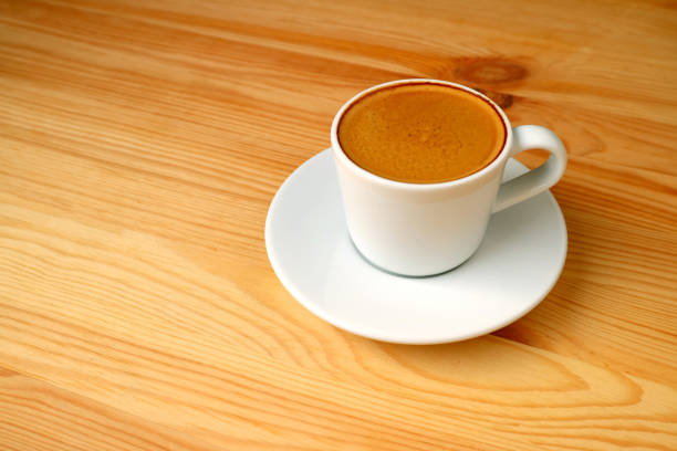 Cup of Hot Espresso Coffee Served on Wooden Table with Free Space for Text and Design
