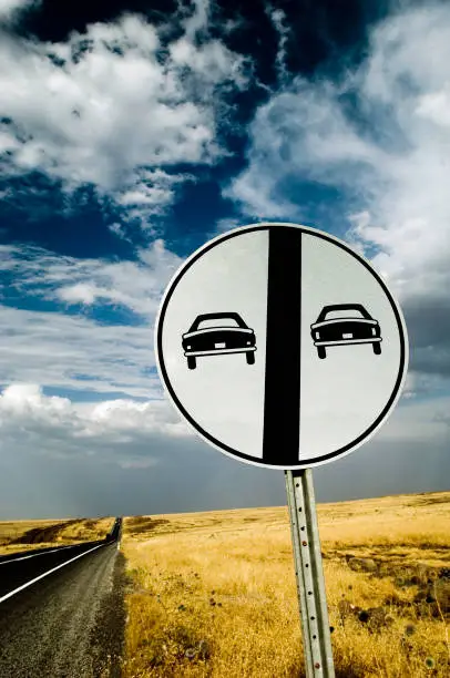 Traffic sign "No Overtaking", on road with many curves, in the state of Minas Gerais