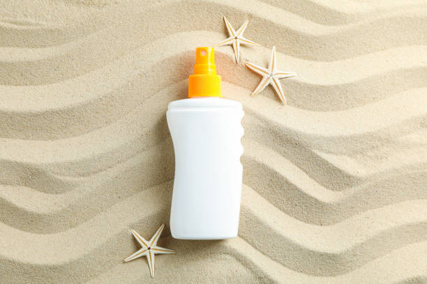 istock Clear sea sand with sunscreen and starfishes, space for text. Summer vacation background 1149416806