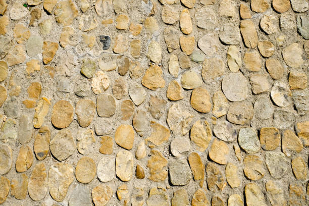 istock Road surface paved with cobblestone in France. Texture for design and background. 1149418018
