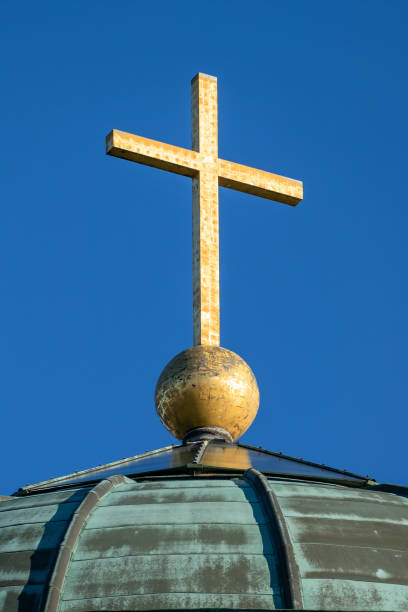 istock golden cross on a roof 1149418019