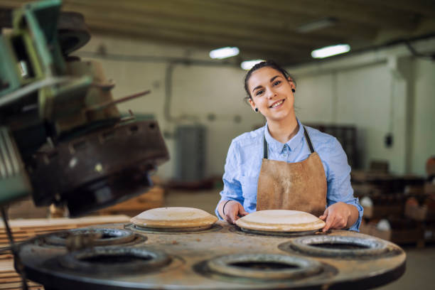 istock Woman Prepare the machine for preparing ceramic plates. 1149426148