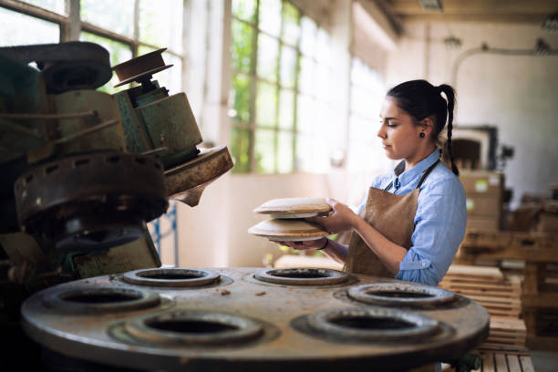 istock Woman Prepare the machine for preparing ceramic plates. 1149426154