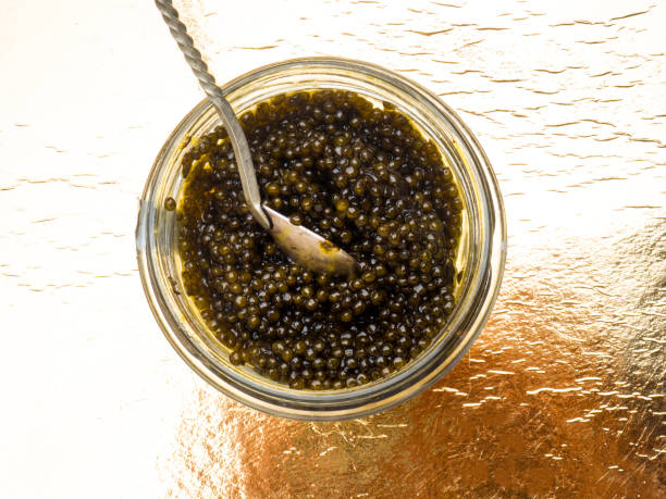 istock Black caviar, luxurious delicacy on golden background 1149426975
