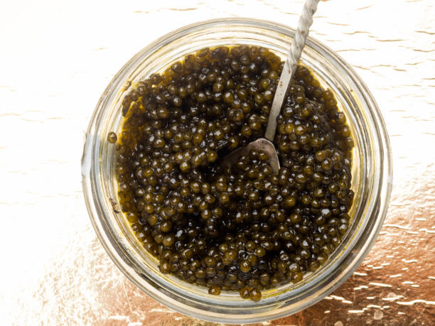 istock Black caviar, luxurious delicacy on golden background 1149426996