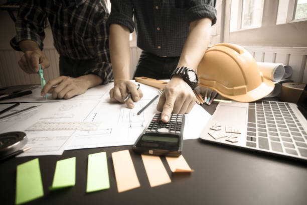 istock Concept Agreement between the employer and architect Nick and desk of Architectural project in construction site or office building with mining light 1149427624