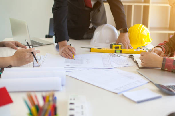 istock Concept Agreement between the employer and architect Nick and desk of Architectural project in construction site or office building with mining light 1149427830